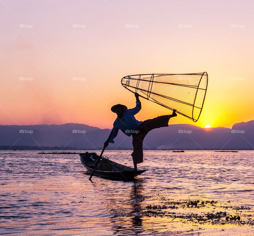 Fisherman pose at lake Inle at sunset, Myanmar 