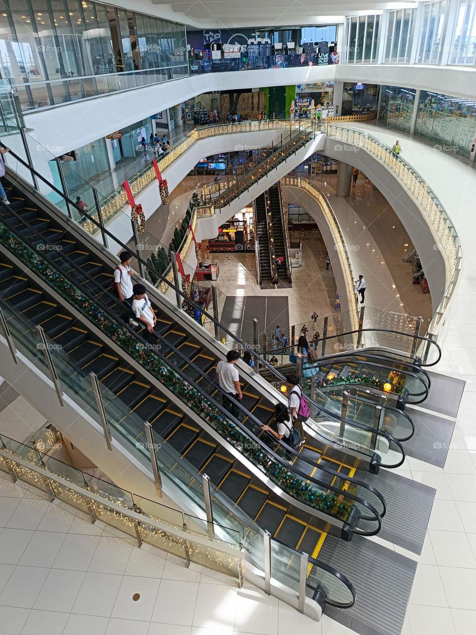 "Life flows upward and downward, much like escalators in a vibrant mall—each step a journey to explore."