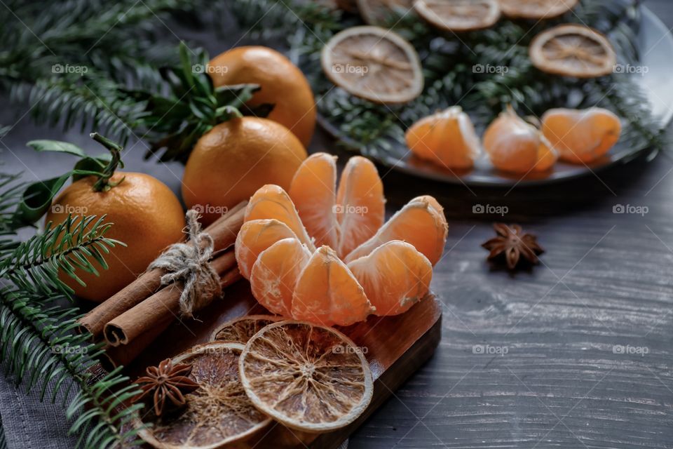 Flatlay mandarin orange cinnamon and Christmas tree branches 