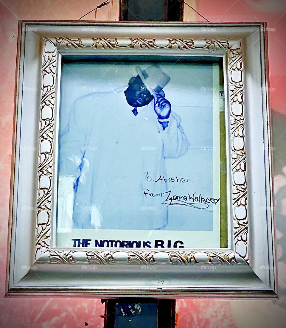 Fashionably dressed tipping his hat to pay his respects to all who know him this is an authentic portrait of the „Notorious B. I. G.“ „Christopher Wallace“ found at the KEYFOOD supermarket on „Fulton St“, Bklyn. 2022. Hypnotic Productions