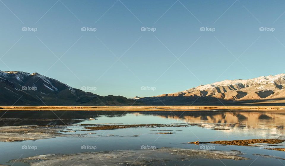 view of lake and mountain  against clear blue sky