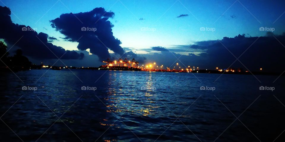 container yard lights reflecting in water