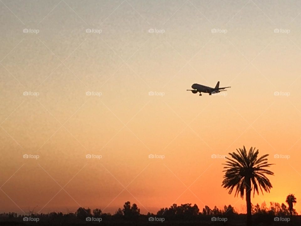 Beautiful airplane flying cross the sky and magic sunset 