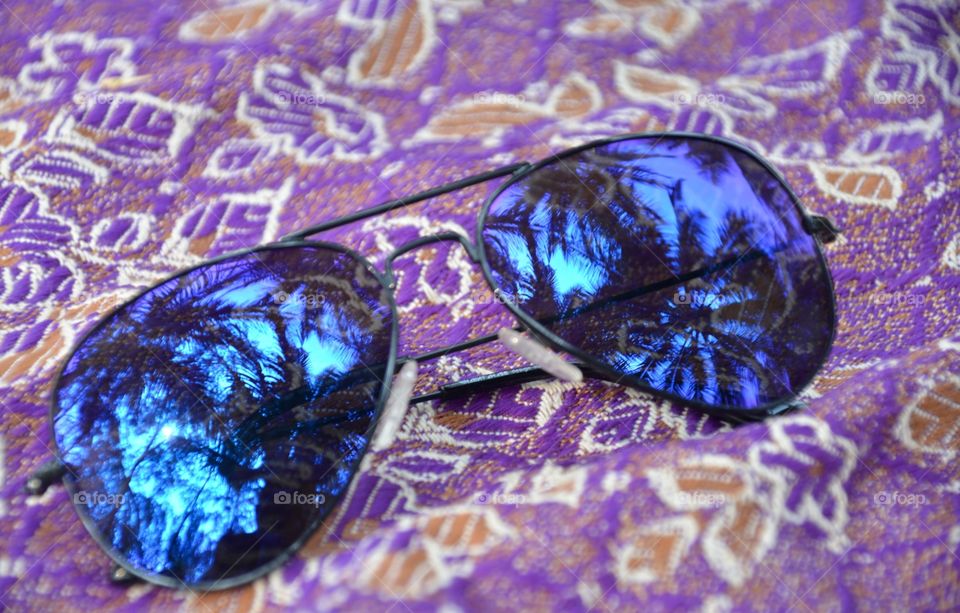 coconut tree reflection in sunglasses