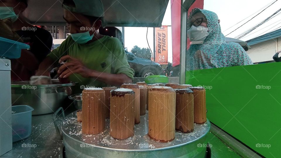 Portrait of Putu Cake, a typical Indonesian street food that is processed by inserting it into pieces of bamboo and steaming it in a pan on the stove. Healthy Food For Vegan.