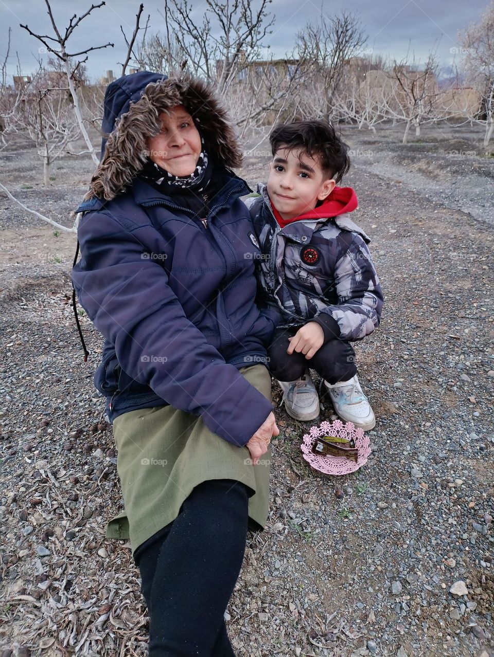 A picture of a smiling old mother whose face is full of fatigue and at the same time full of hope