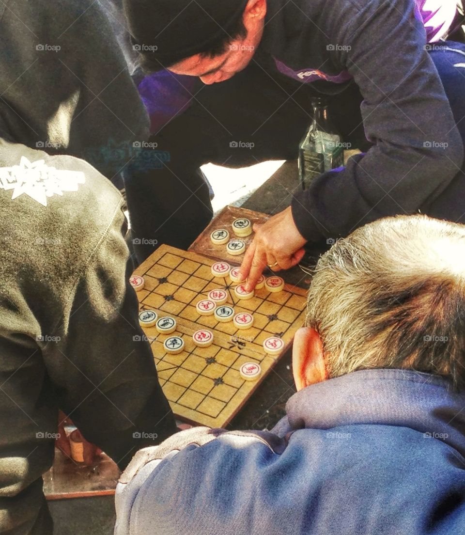 Chinese men playing traditional xiangqi game