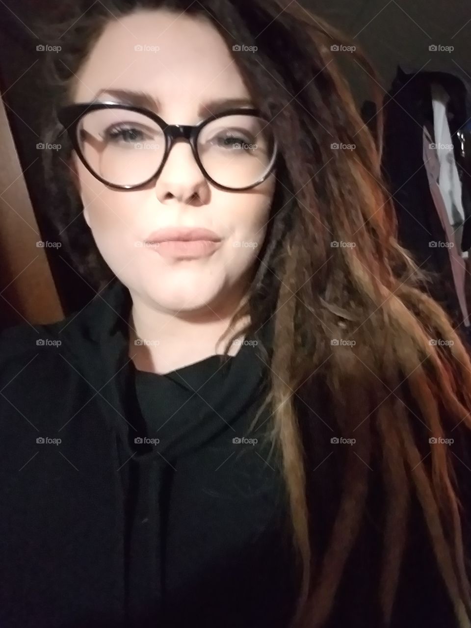 Woman in black with glasses. She is proud.