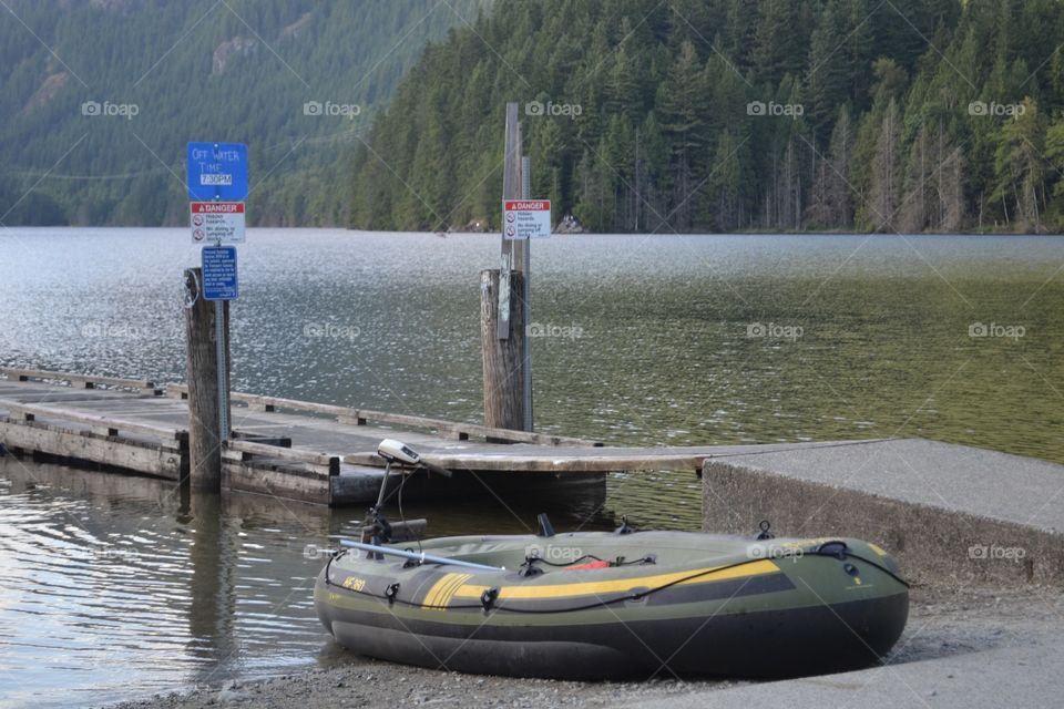 Inflatable boat at lake boat launch. Inflatable boat at lake boat launch