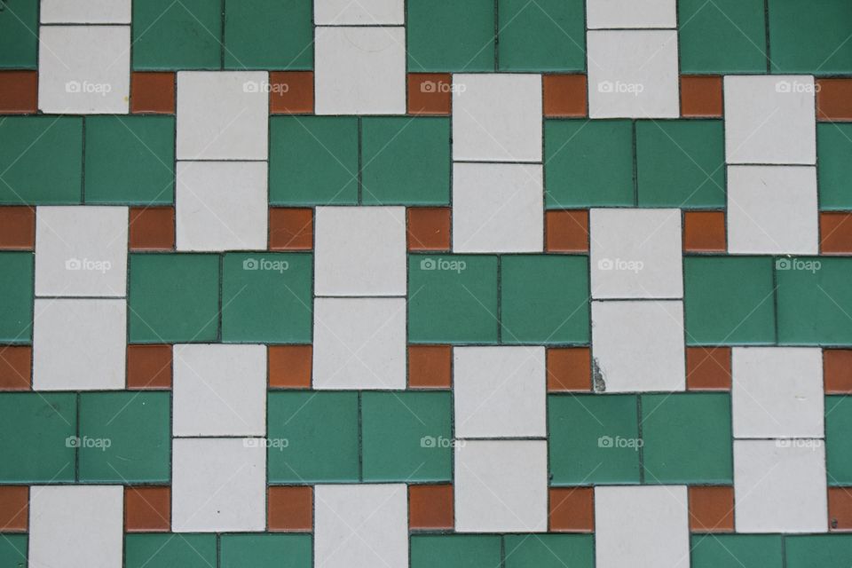 A colorful closeup abstract of a tiled wall.