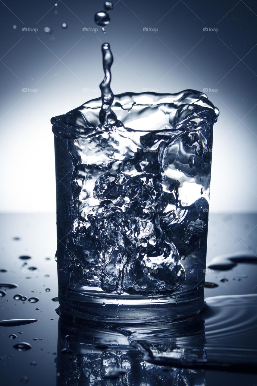 glass of water with splash from falling ice cube