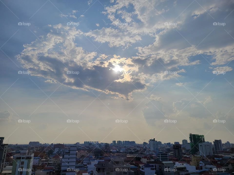 Clouds holding sun Phnom Penh Cambodia