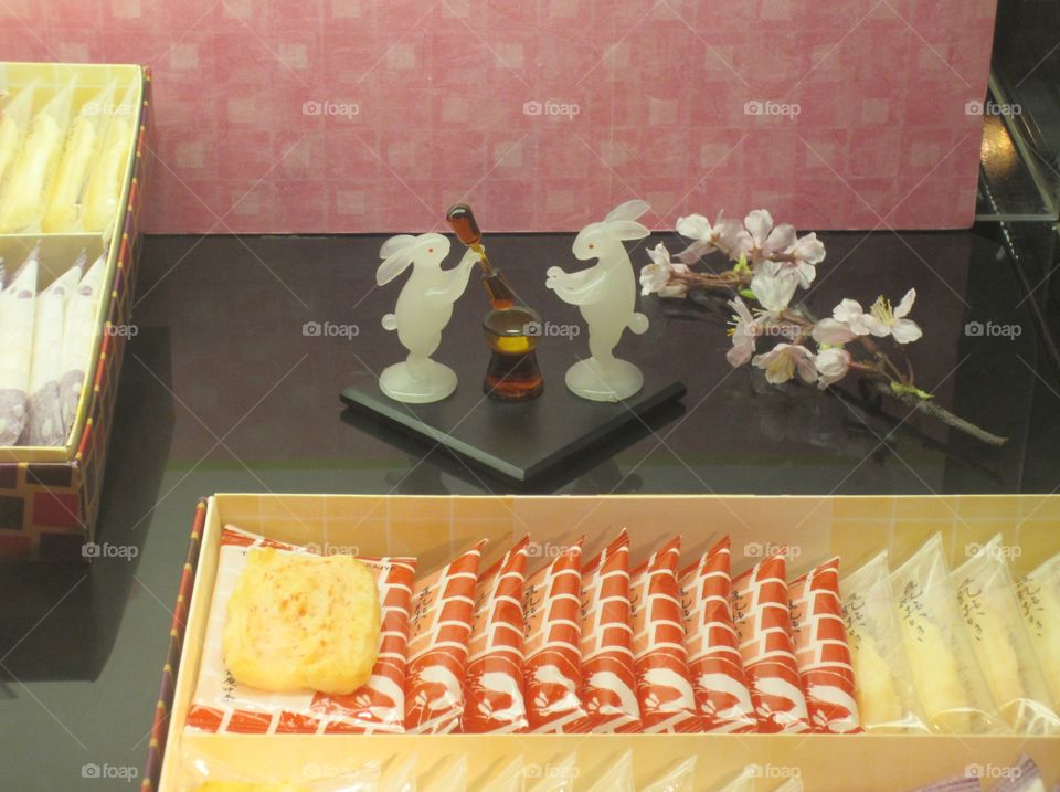 Glass Rabbits Display in a Shop Window, Ginza, Tokyo, Japan.  Japanese Snacks Advertisement. Spring cherry blossom theme. Sakura season.