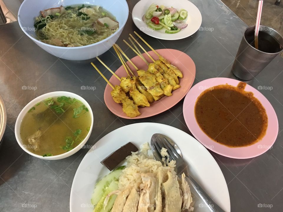 Eggs noodles and wonton soup, stream chicken and rice, satay pork 