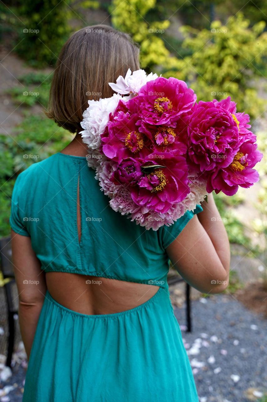 Girl with a bouquet of peonies