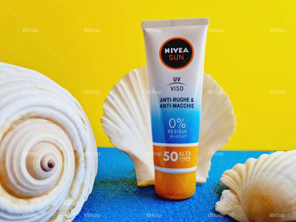 Nivea Sun sunscreen in the foreground surrounded by sea shells