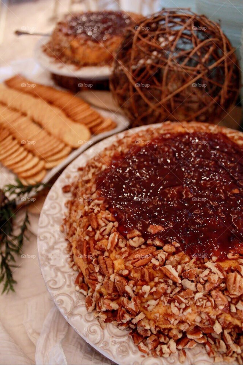 Cheese ball with pecans and jam with crackers