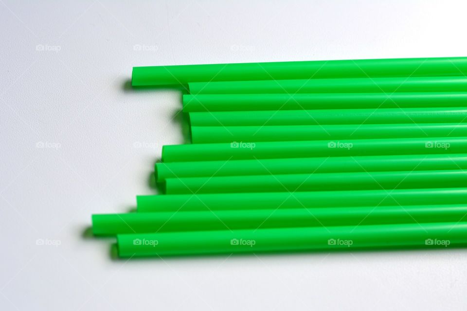 Green straw on white background