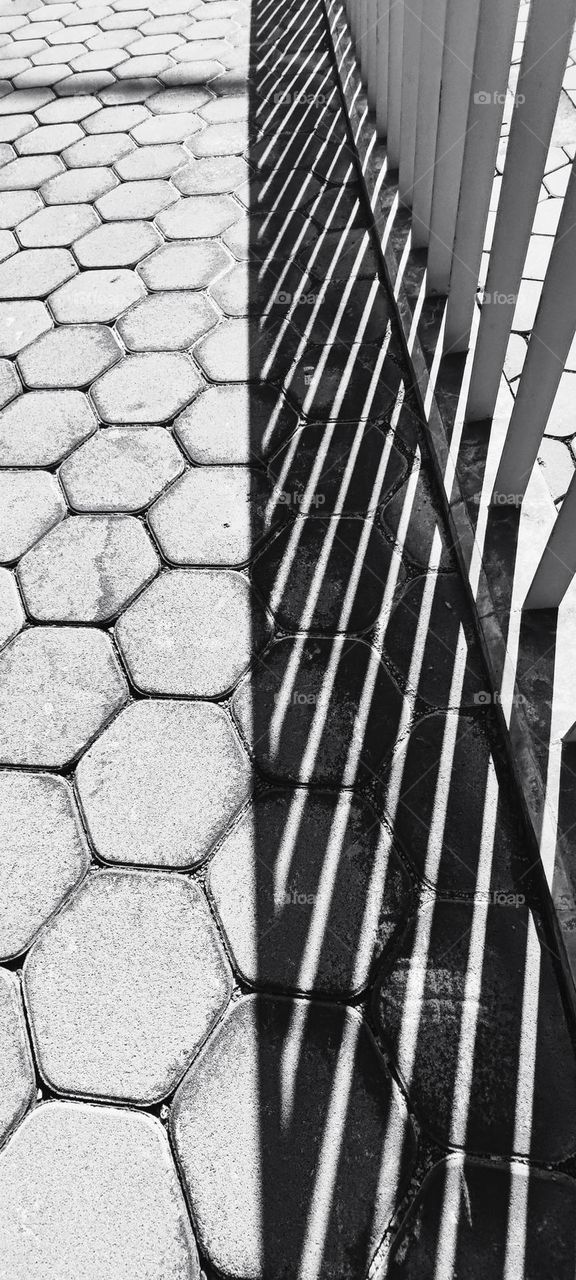 Floor bricks and shadow of handrail