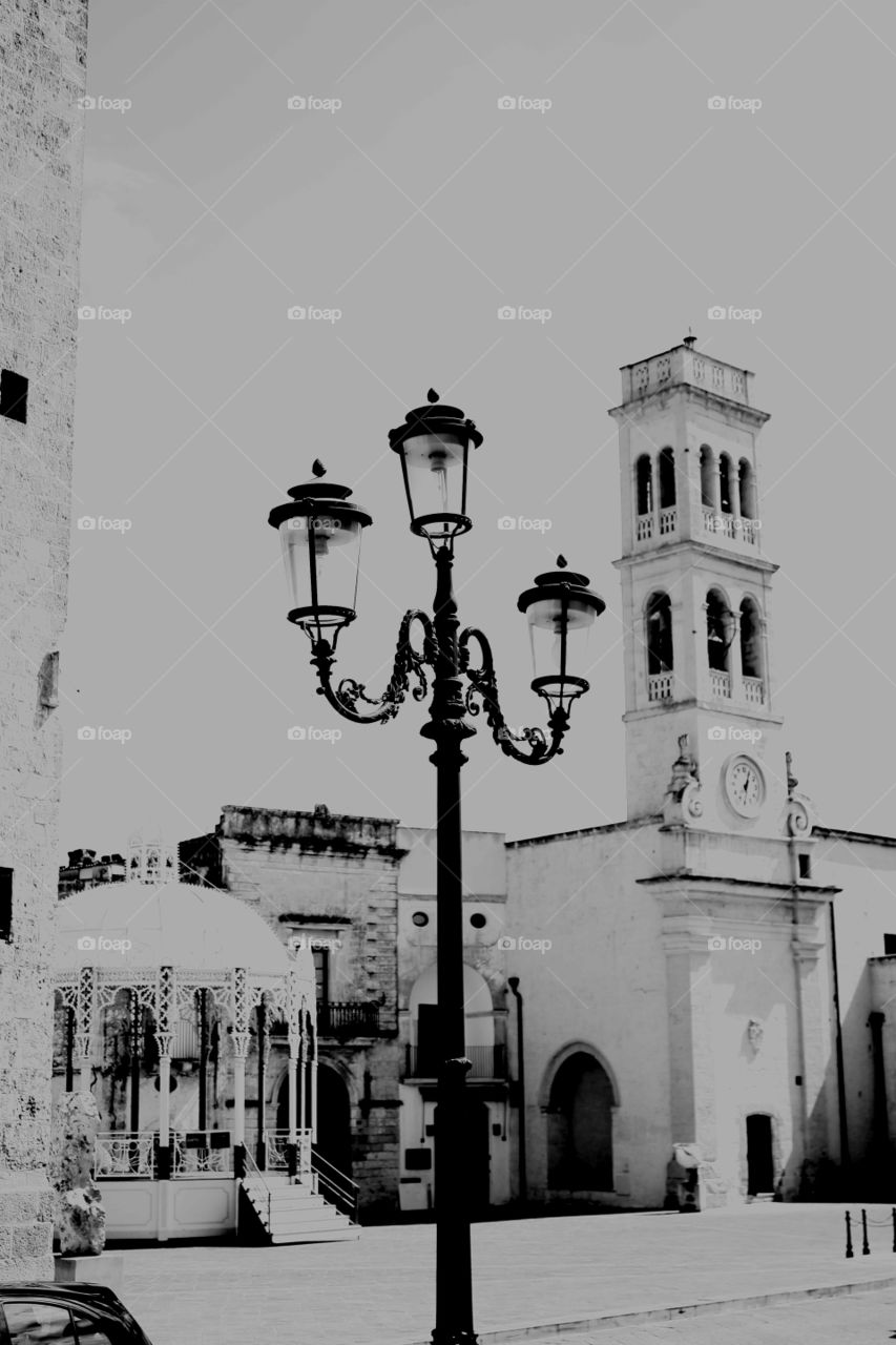 Picturesque black and white view of Lecce, Italy. Main square: an old light pole.