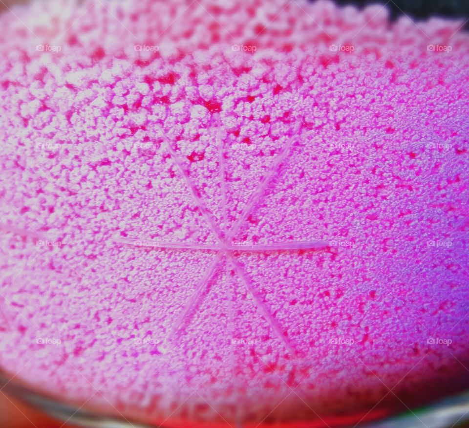 Pink sand like looking substance.... with a imprint of a snowflake.