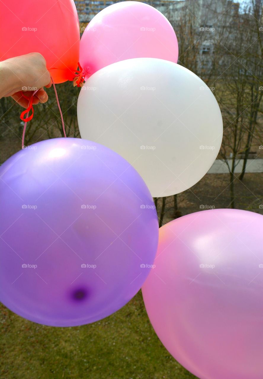 colour helium balloons in the hand flying