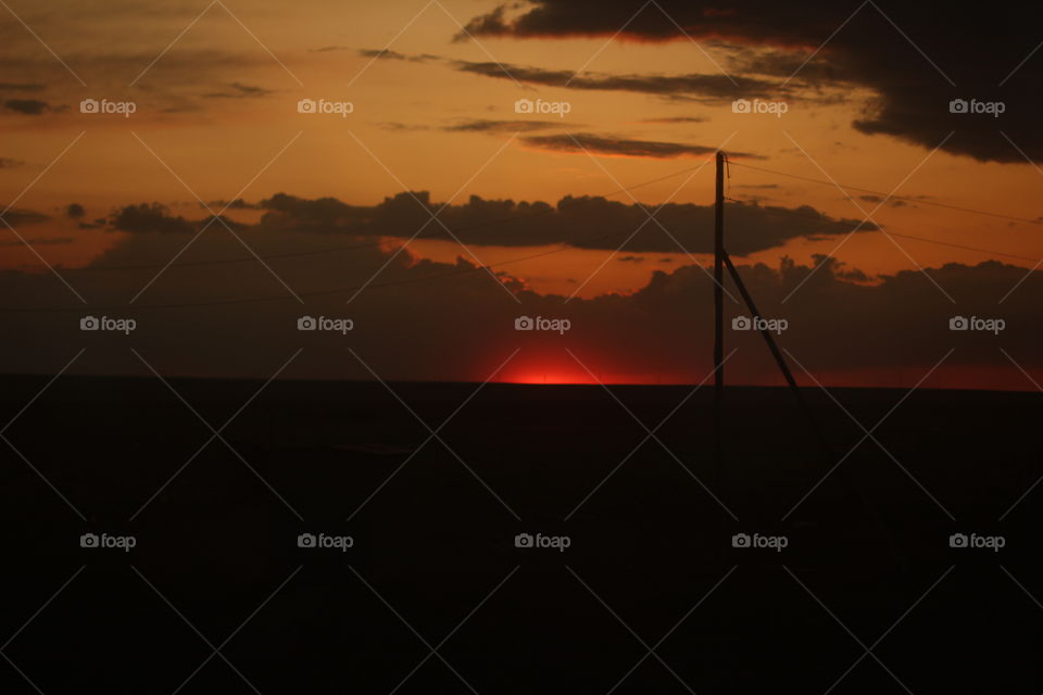 Wooden power pole in red sunset
