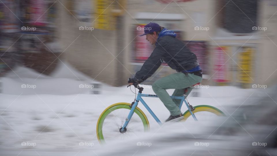 Urban biker during a snowy day in Bucharest