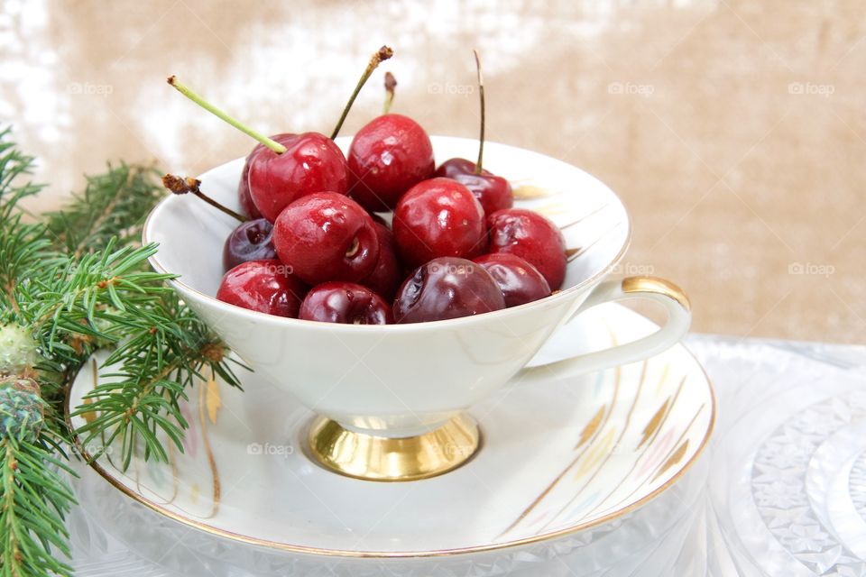 cherries in teacup