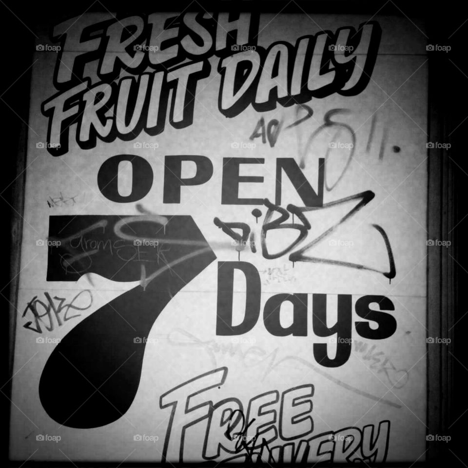 Fruit shop sign slightly vandalised