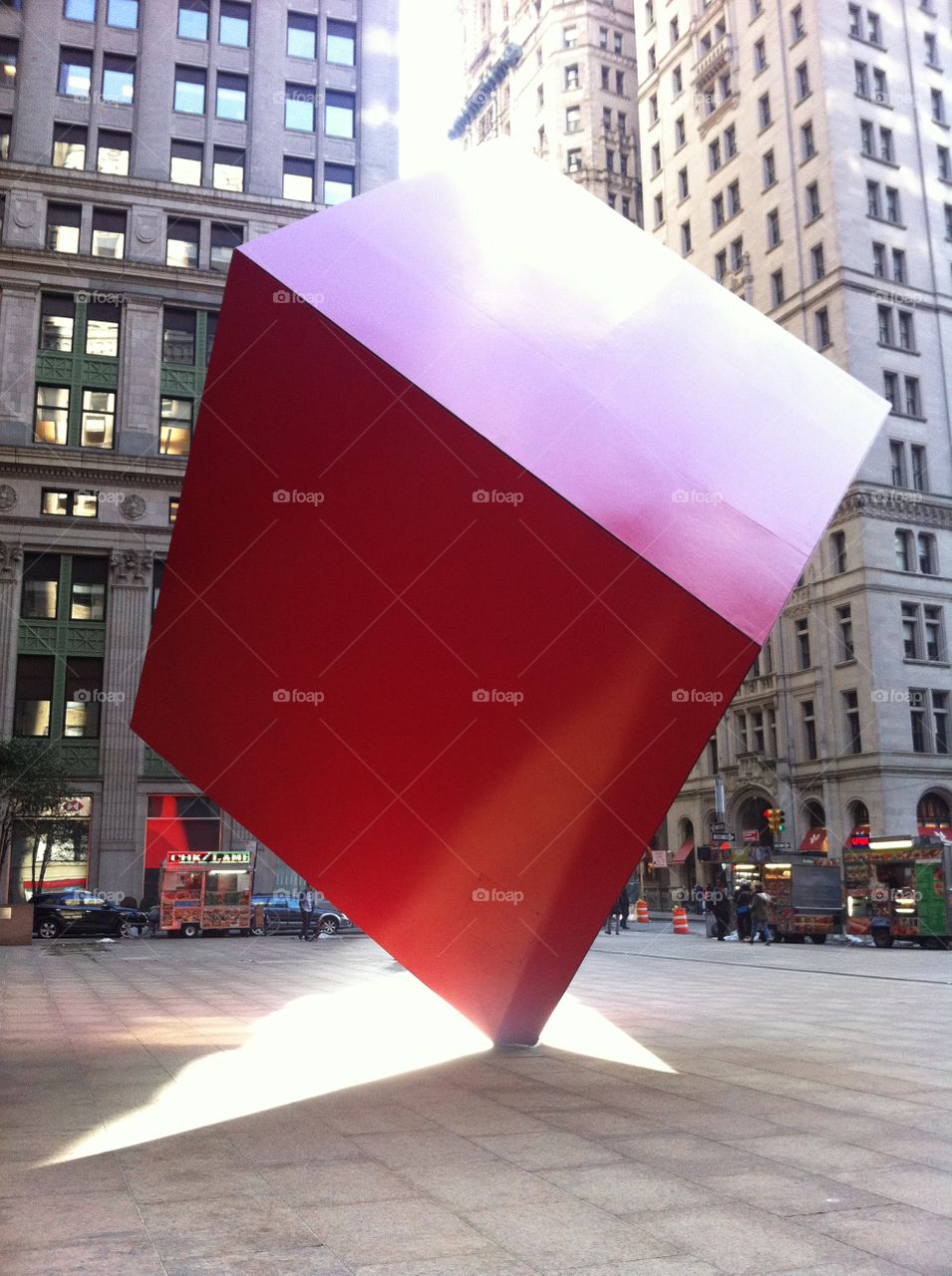 Red in New York. Giant red cube stands on end on a sunny day in New York City