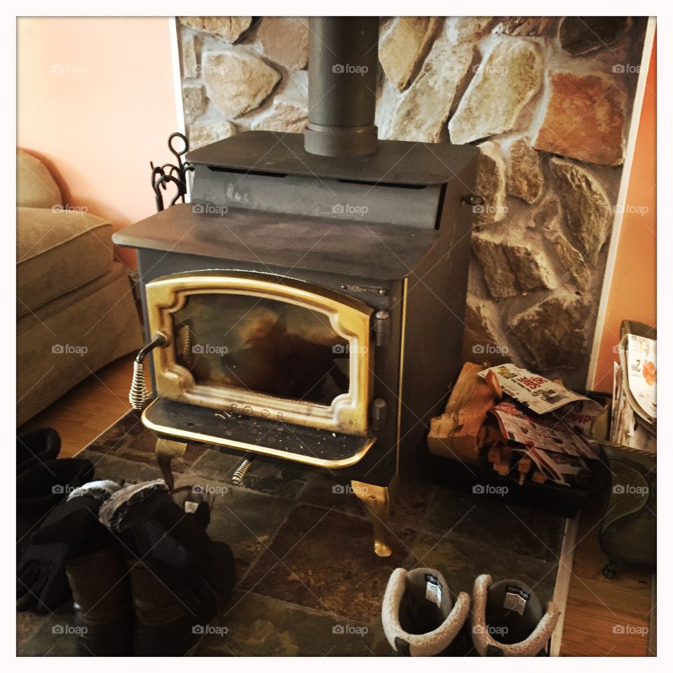 Drying shoes by the wood stove fire 