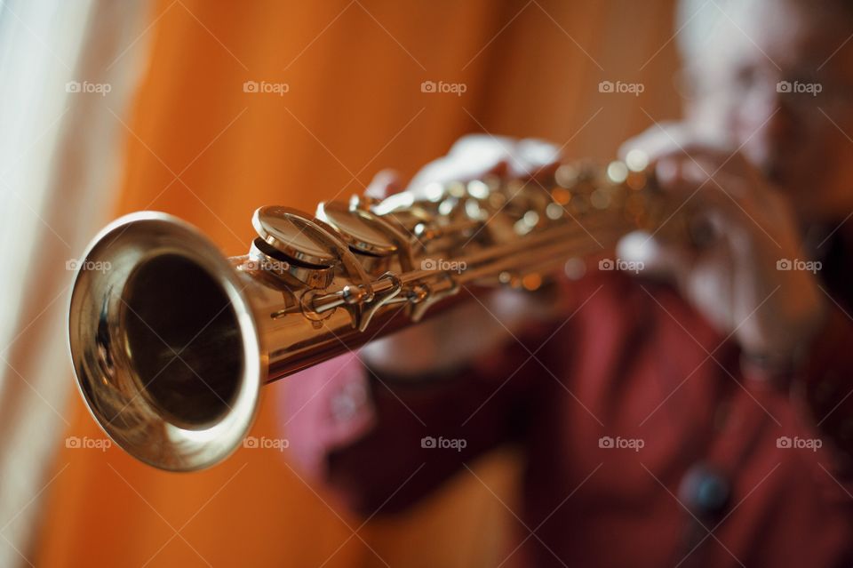 Closeup of man playing trumpet