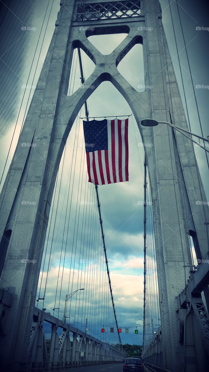 American flag hung from a bridge