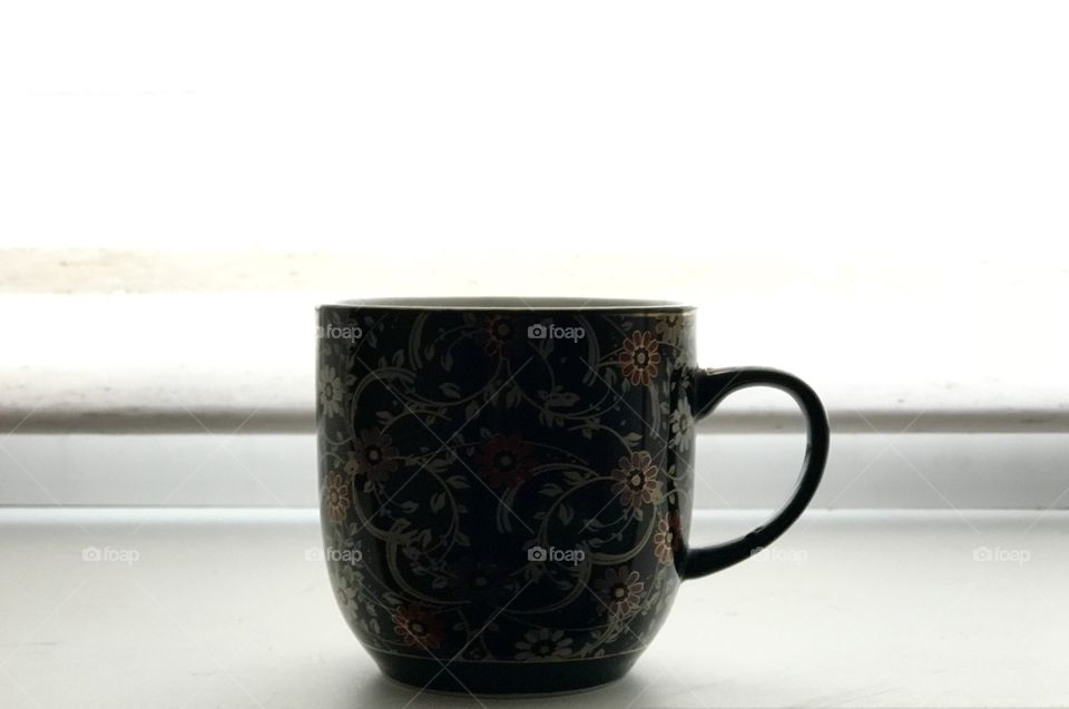 Cup of coffee on the windowsill 