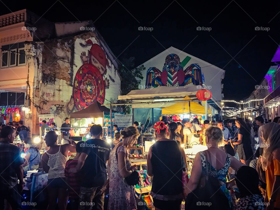 Crowd of tourists enjoy shopping at Lardyai night walking street market in Phuket downtown, popular resort city of southern Thailand