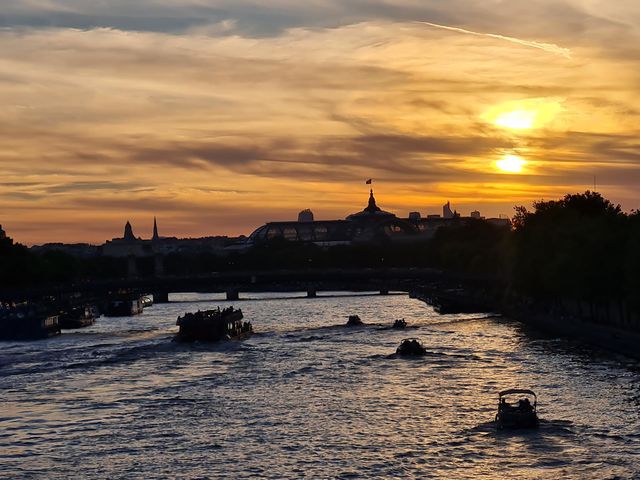 boats sailing into the sunset