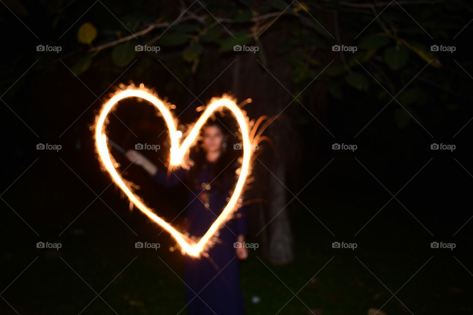 A heart painted in air using a sparkler duri g celebrations of diwali