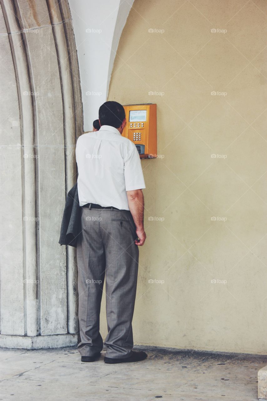 Man calling at telephone at the street 