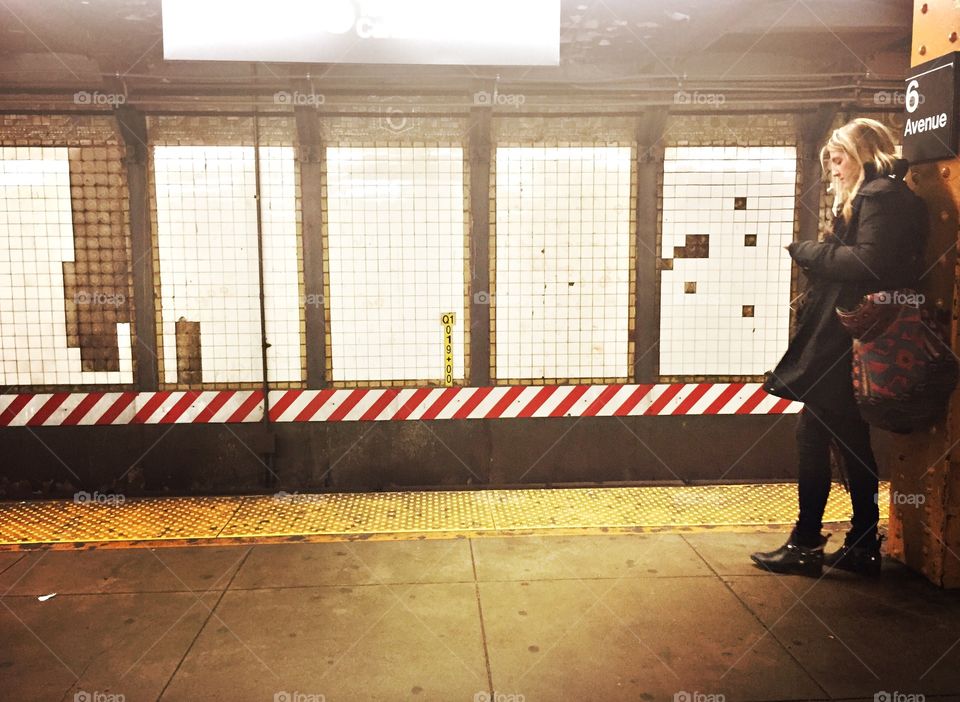 Women waiting standing in subway station 