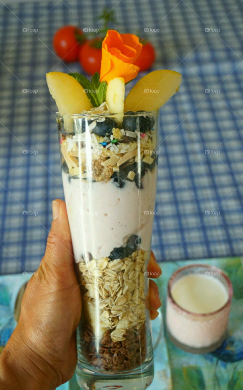 Fresh fruit smoothie - blueberry banana coconut strawberries and nuts