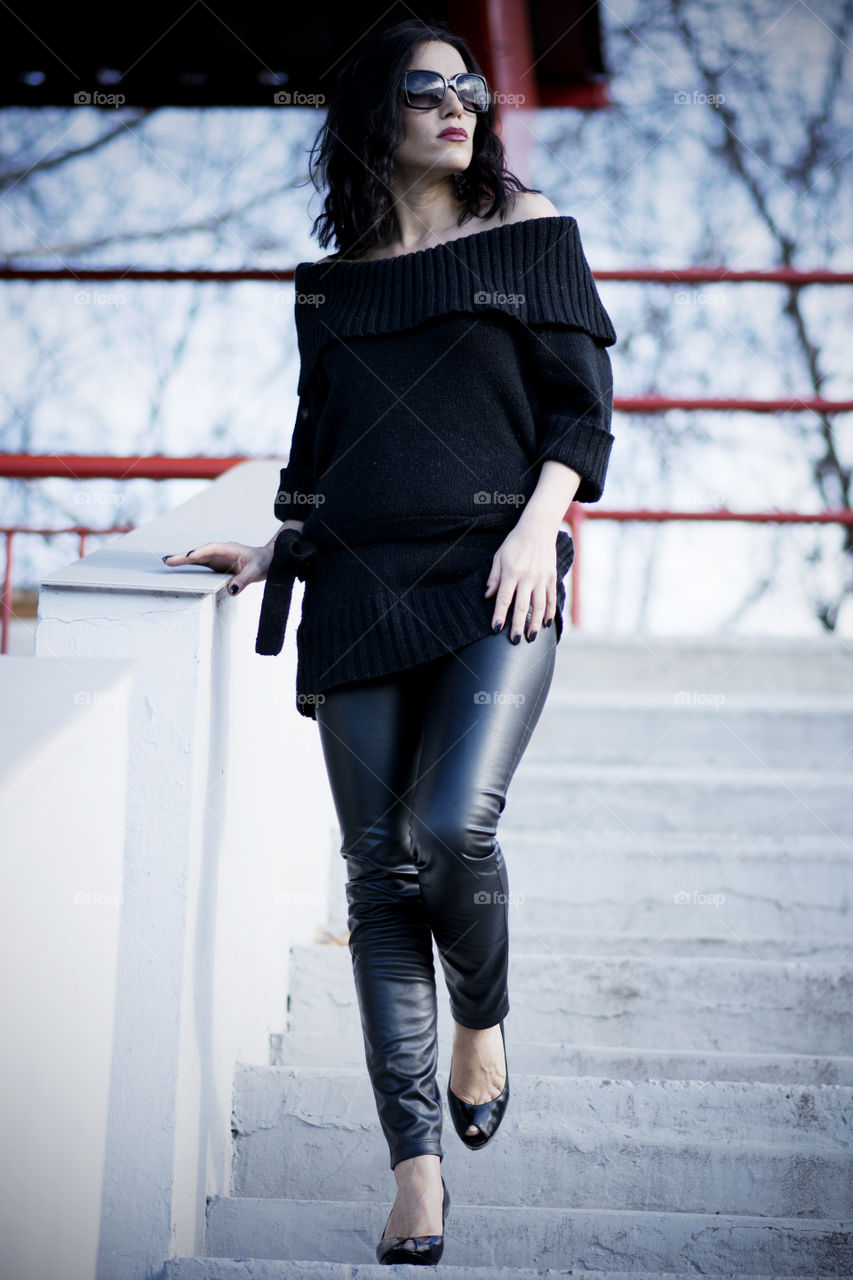 Beautiful woman walking on staircase