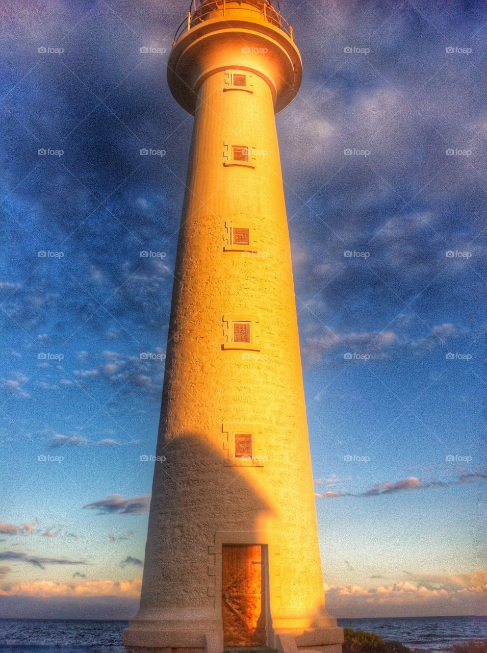 Golden Glow of the late sun on the lighthouse. Golden Glow of the late sun on the lighthouse