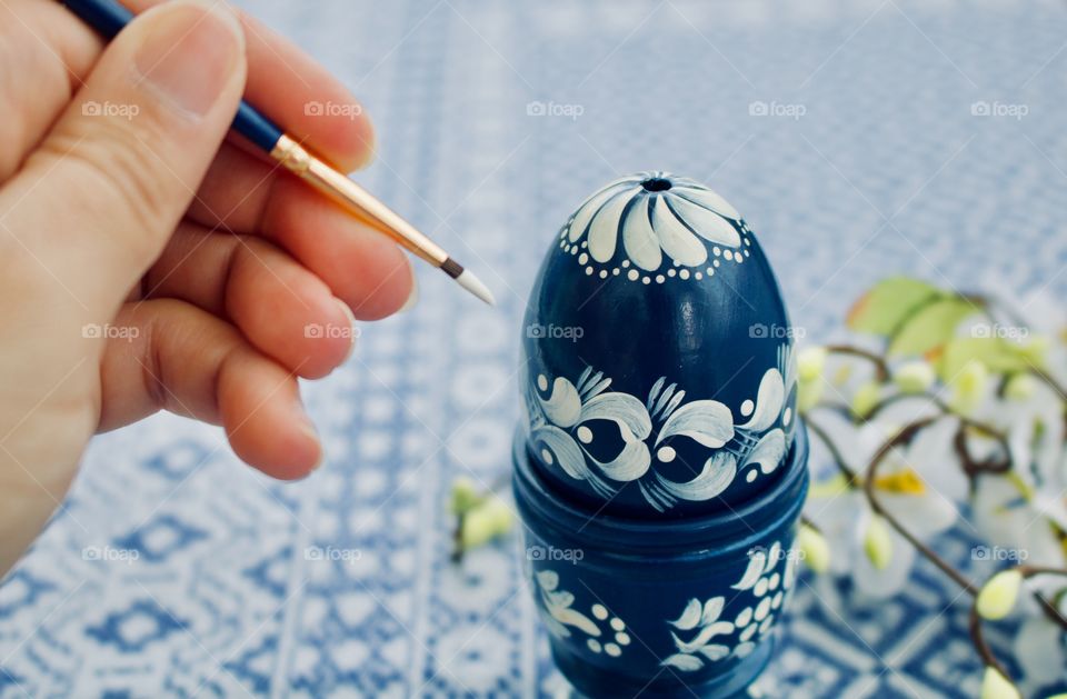 Painting an egg for Easter 