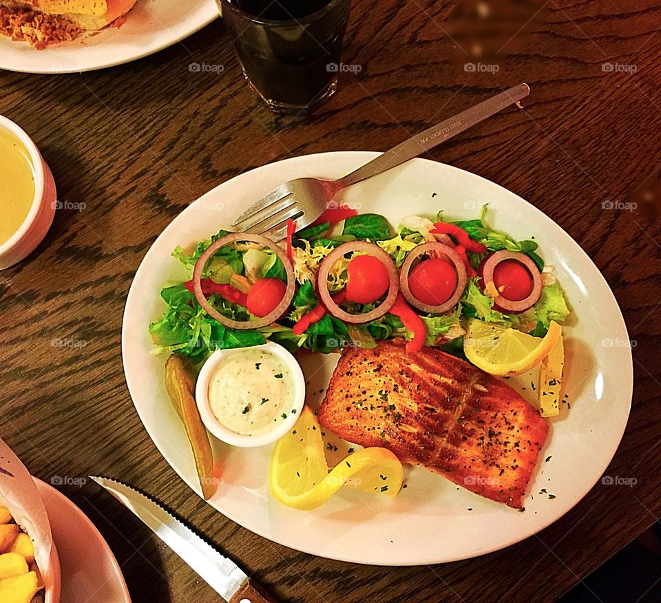 Salmon fish served with salad,, on health kick 