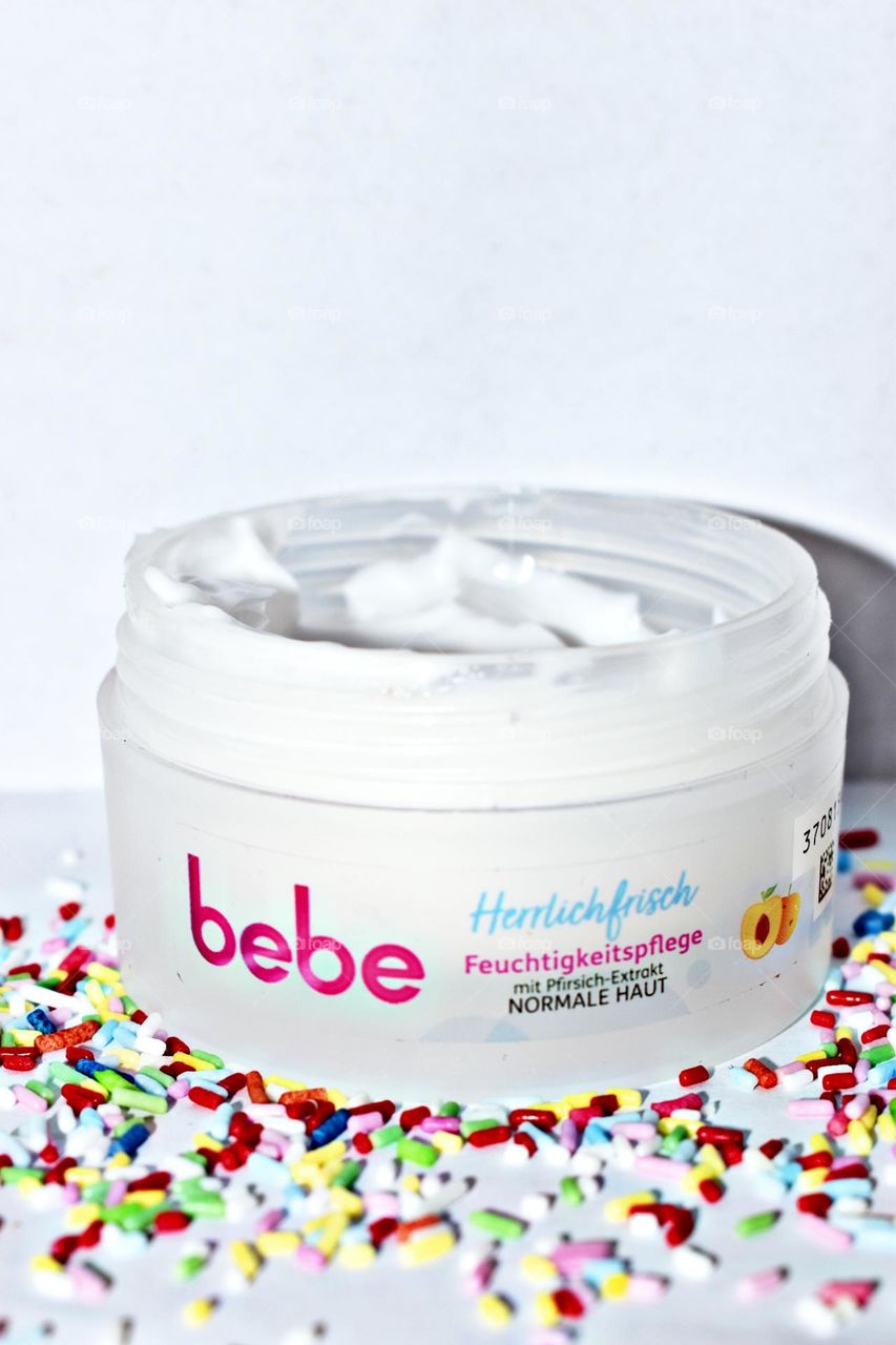 Soft peach cream surrounded by sugar sprinkles.