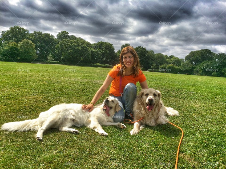 Woman with dog on grassy field