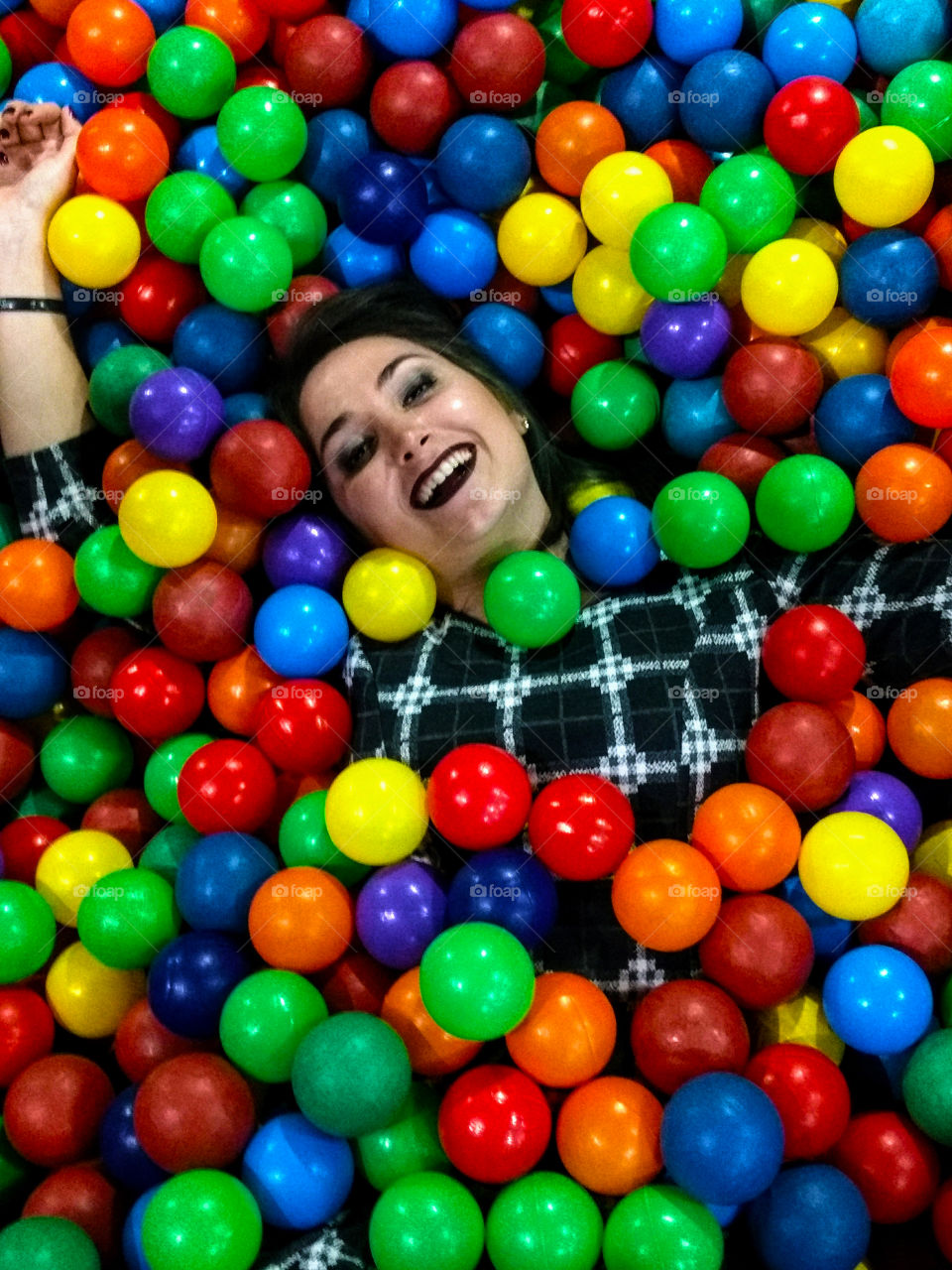 Young woman playing in a ball pool