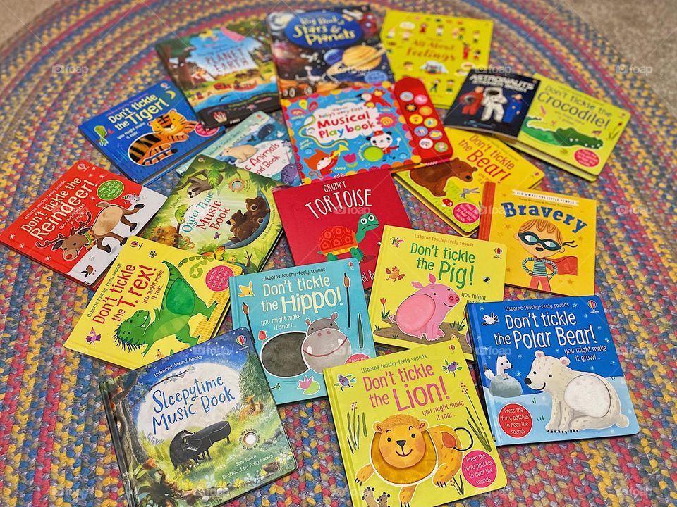 Pile of books on the floor, toddler receives free books from Usbourne book company, lots of books for toddlers, piling up books to read, reading is fun 