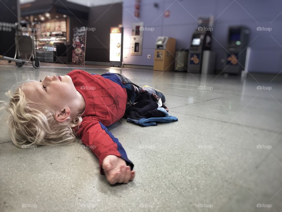 Little boy lying on flooring
